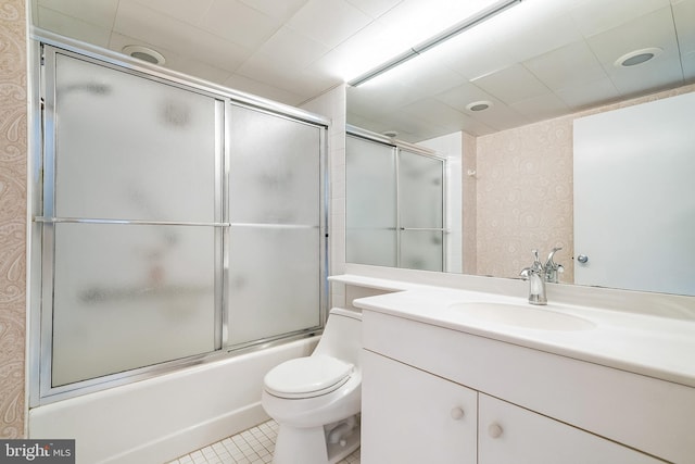 full bathroom with vanity, tile patterned flooring, enclosed tub / shower combo, and toilet