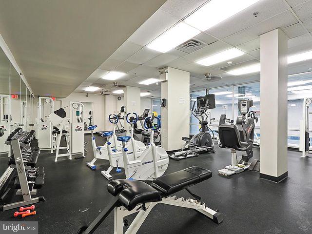 workout area featuring a drop ceiling