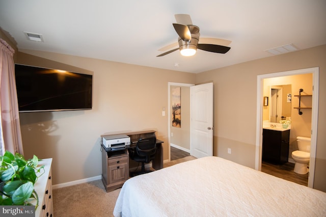 carpeted bedroom with connected bathroom and ceiling fan