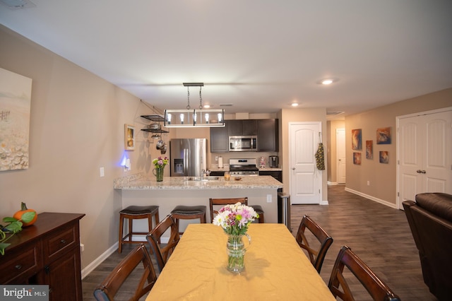 dining space with dark wood-type flooring