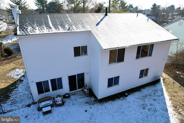 rear view of property with a chimney