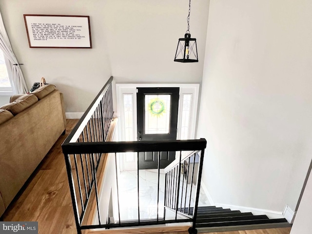 stairs with baseboards and wood finished floors