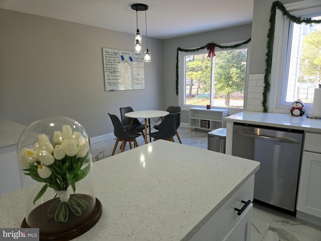 kitchen featuring dishwasher, baseboards, and marble finish floor