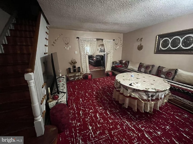 interior space featuring carpet floors and a textured ceiling