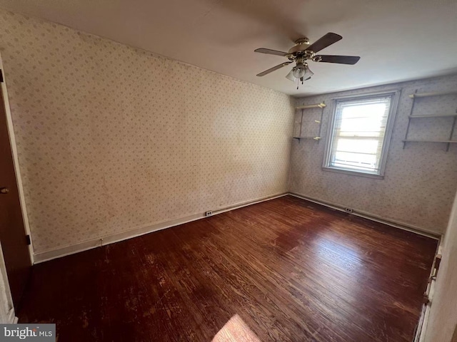 spare room with ceiling fan and dark hardwood / wood-style floors