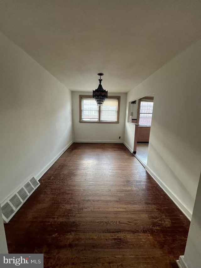 spare room featuring dark hardwood / wood-style flooring