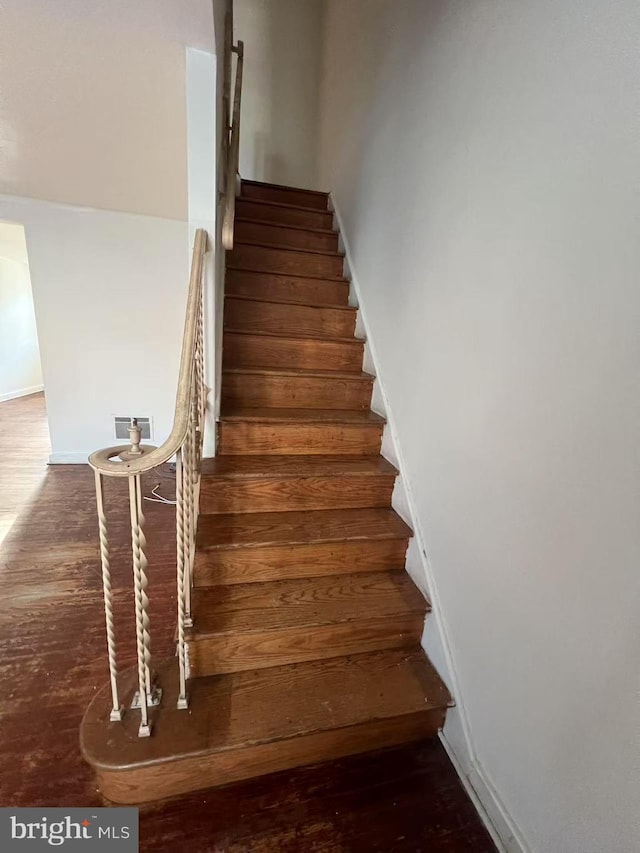 stairway with hardwood / wood-style floors