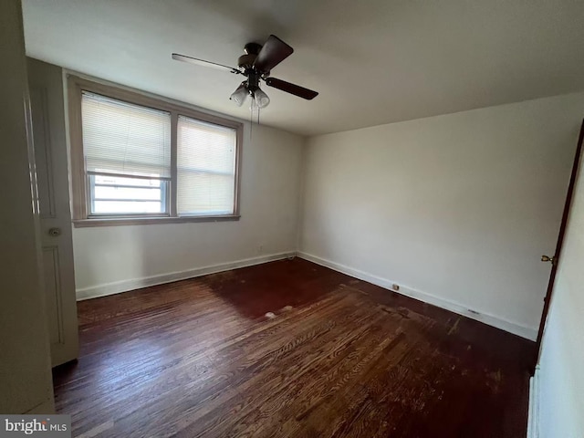 spare room with ceiling fan and dark hardwood / wood-style floors