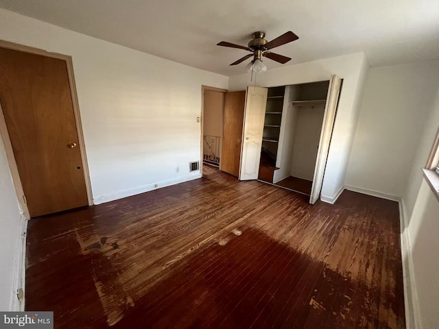 unfurnished bedroom featuring ceiling fan and dark wood-type flooring