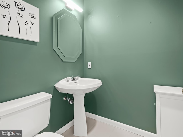 bathroom with tile patterned flooring and toilet