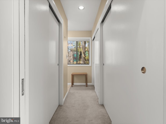 hallway with light colored carpet