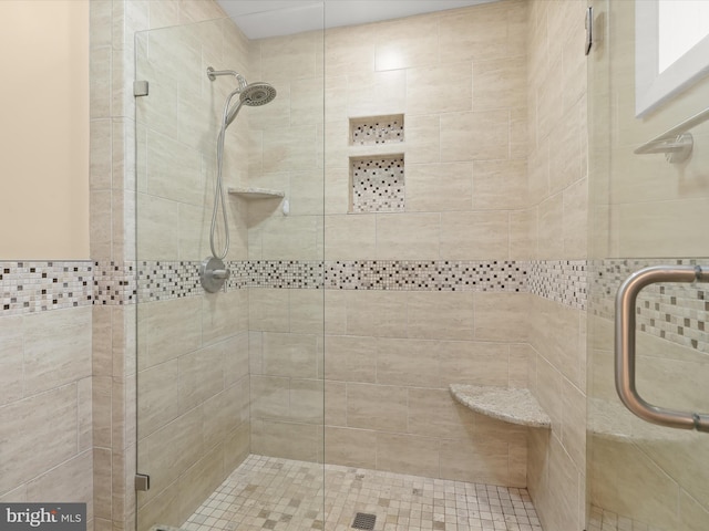 bathroom featuring a shower with door