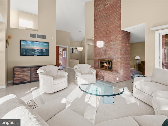 living room with a fireplace, a high ceiling, and light tile patterned floors