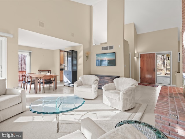 tiled living room with a towering ceiling