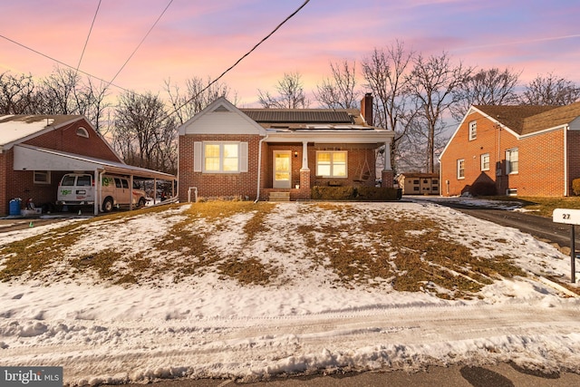 view of front of property featuring a porch and a carport