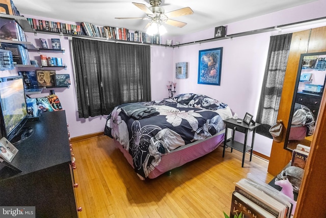 bedroom with ceiling fan and hardwood / wood-style flooring