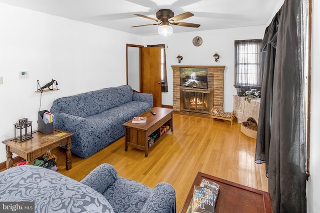 living room featuring ceiling fan and hardwood / wood-style flooring