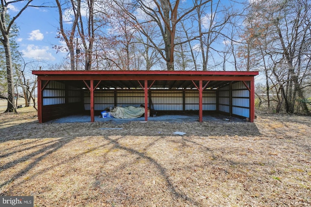 view of car parking featuring a carport and a pole building