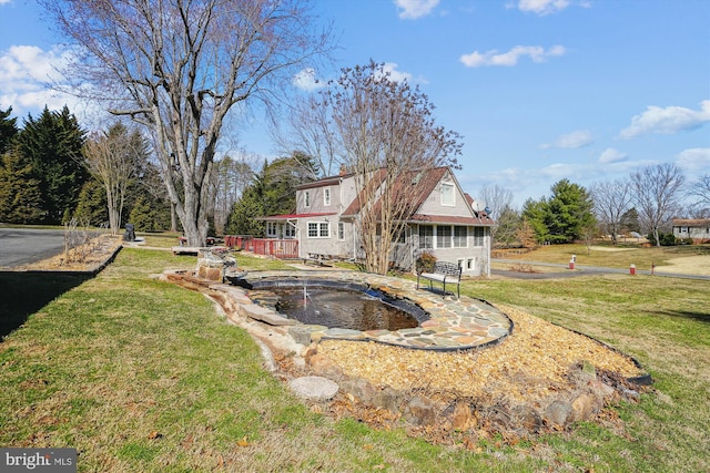 back of house featuring a yard and a wooden deck