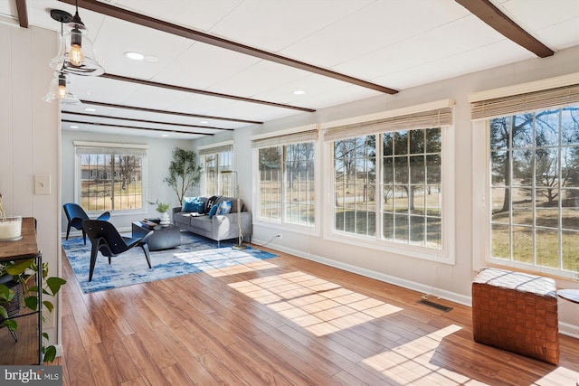 sunroom with visible vents and beam ceiling