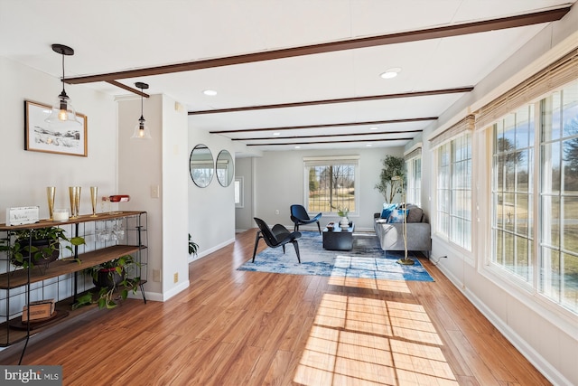 sitting room with recessed lighting, beamed ceiling, light wood-style flooring, and baseboards