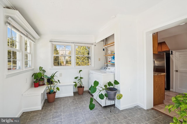 washroom featuring laundry area, independent washer and dryer, and baseboards