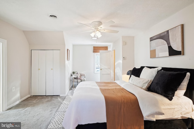 carpeted bedroom featuring a ceiling fan, a closet, visible vents, and baseboards