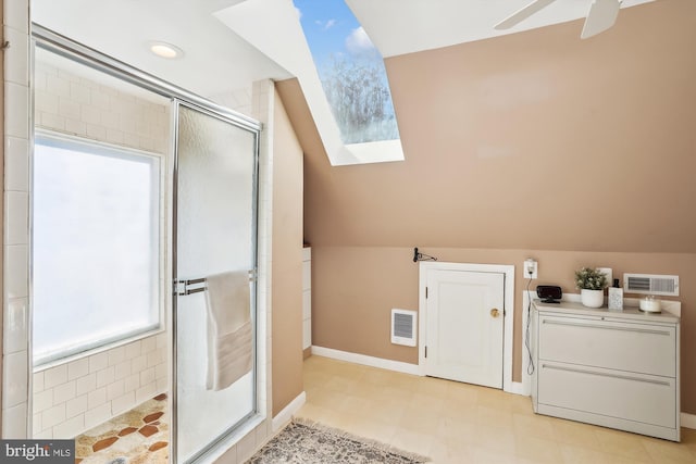 full bath featuring visible vents, lofted ceiling with skylight, ceiling fan, tile patterned floors, and a shower stall