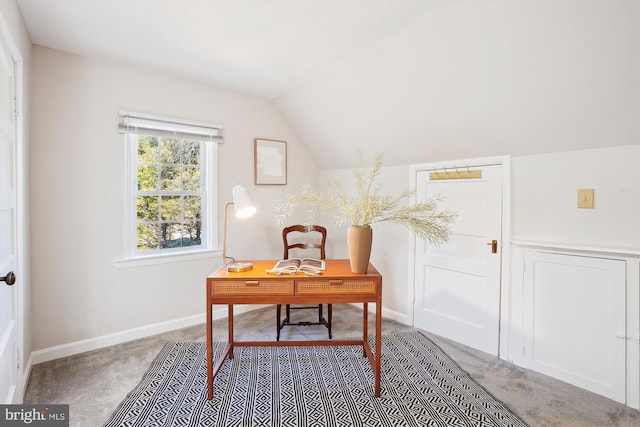 office area featuring vaulted ceiling, carpet, and baseboards