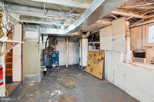 basement featuring water heater and a heating unit