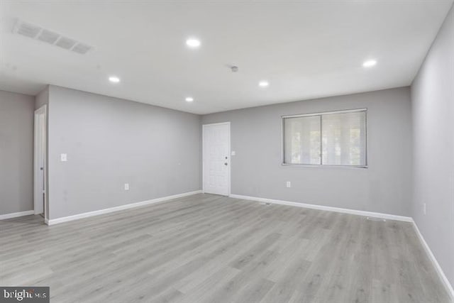 empty room with light hardwood / wood-style flooring