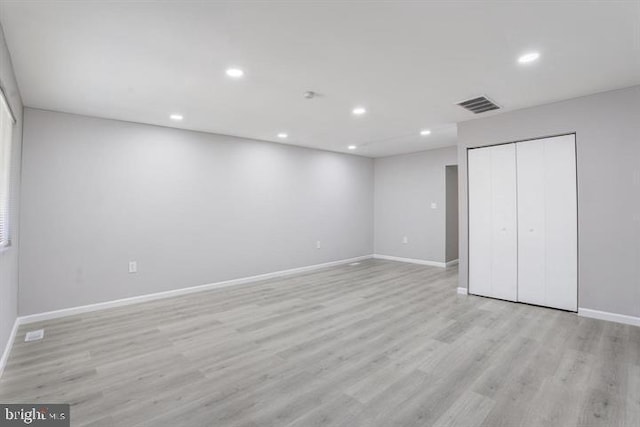 unfurnished bedroom with a closet and light hardwood / wood-style flooring