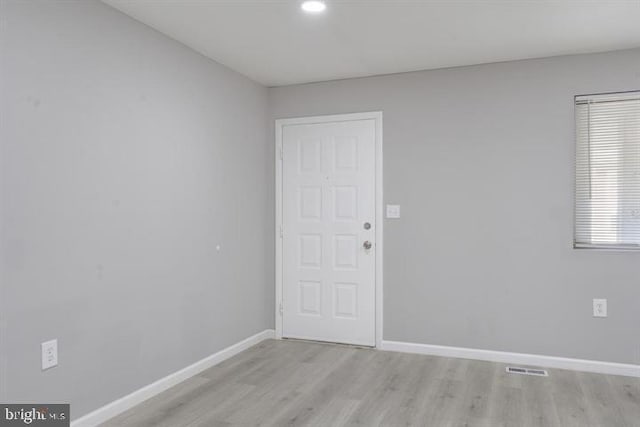 spare room featuring light hardwood / wood-style floors