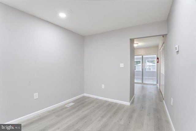 unfurnished room with light hardwood / wood-style floors