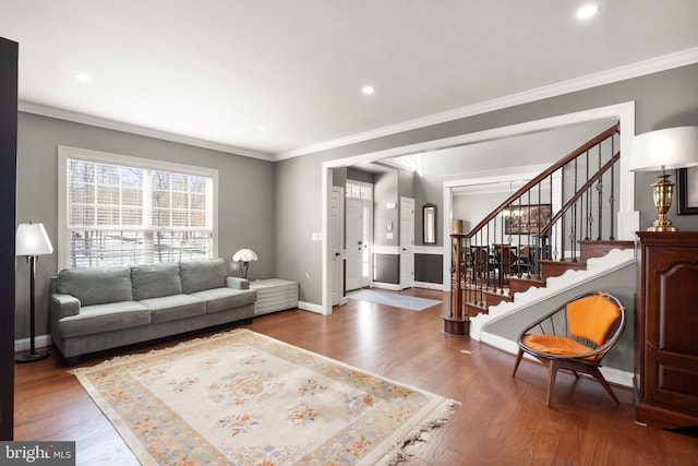 living room featuring hardwood / wood-style flooring and ornamental molding