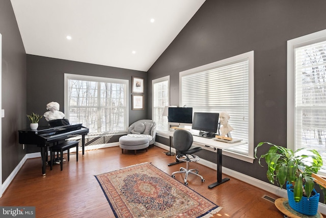 home office with wood-type flooring and lofted ceiling