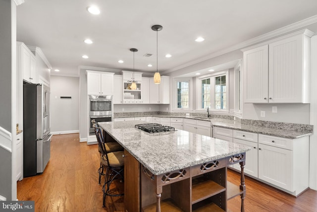 kitchen with white cabinetry, a center island, and appliances with stainless steel finishes