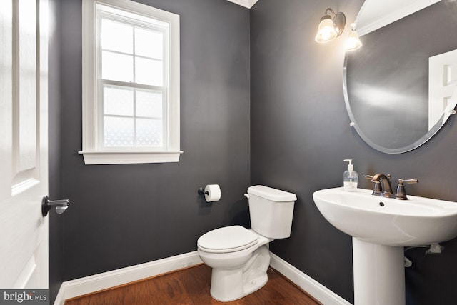 bathroom featuring hardwood / wood-style flooring, toilet, and sink