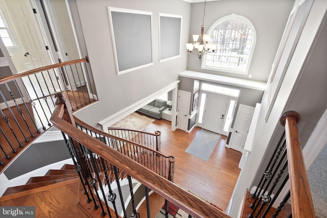 foyer entrance with a chandelier, a high ceiling, and hardwood / wood-style flooring