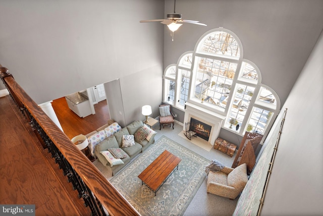 living room with a towering ceiling and ceiling fan