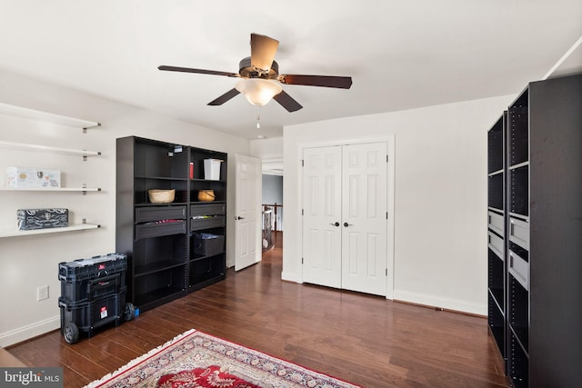 interior space with ceiling fan and dark hardwood / wood-style flooring