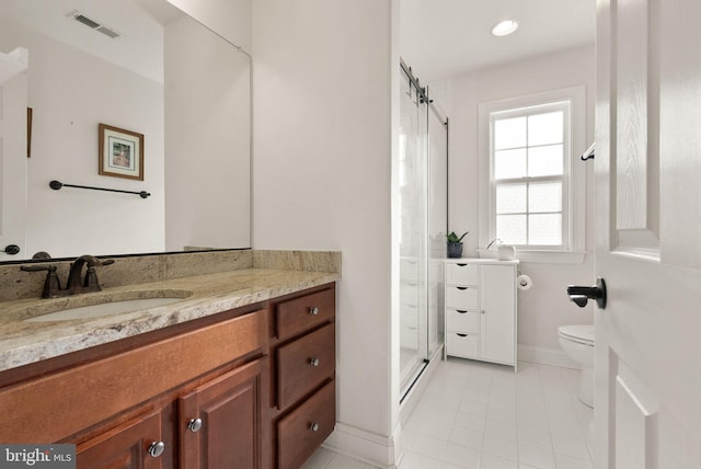 bathroom with tile patterned floors, vanity, toilet, and a shower with shower door