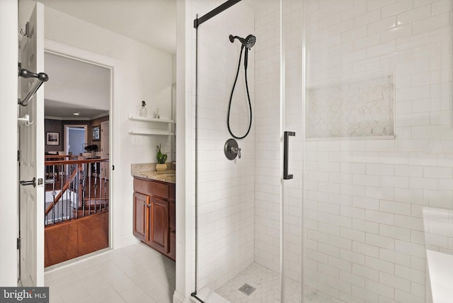 bathroom with tile patterned floors, vanity, and walk in shower