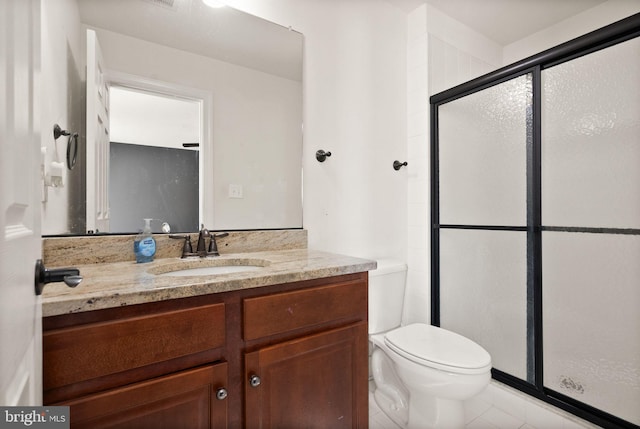 bathroom featuring tile patterned floors, vanity, toilet, and an enclosed shower