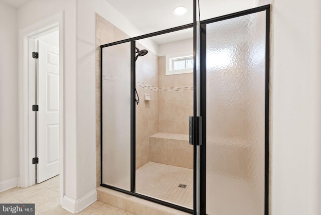 bathroom with tile patterned flooring and a shower with door