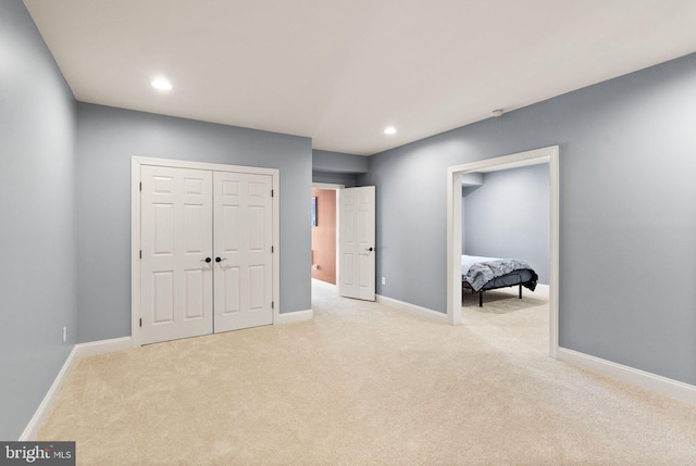 bedroom with a closet and light colored carpet