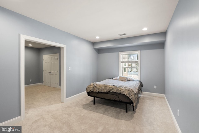 bedroom featuring light colored carpet