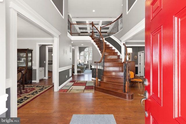 foyer entrance featuring crown molding and dark hardwood / wood-style flooring