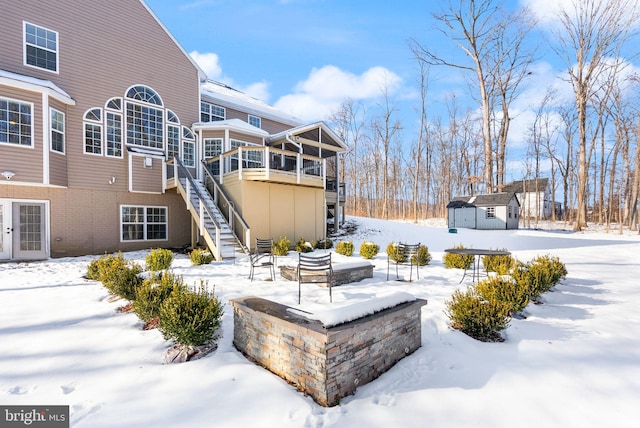 yard layered in snow with a storage unit