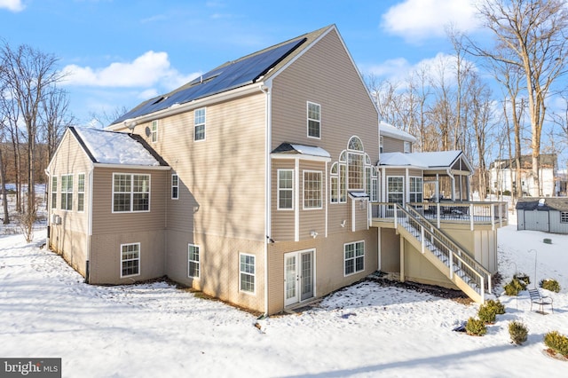 snow covered house featuring a deck